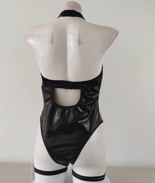 Bold and provocative leather bodysuit featuring fishnet accents